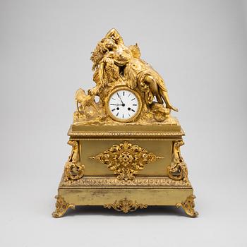 A mid 19th Century brass and gilt brass mantel clock.