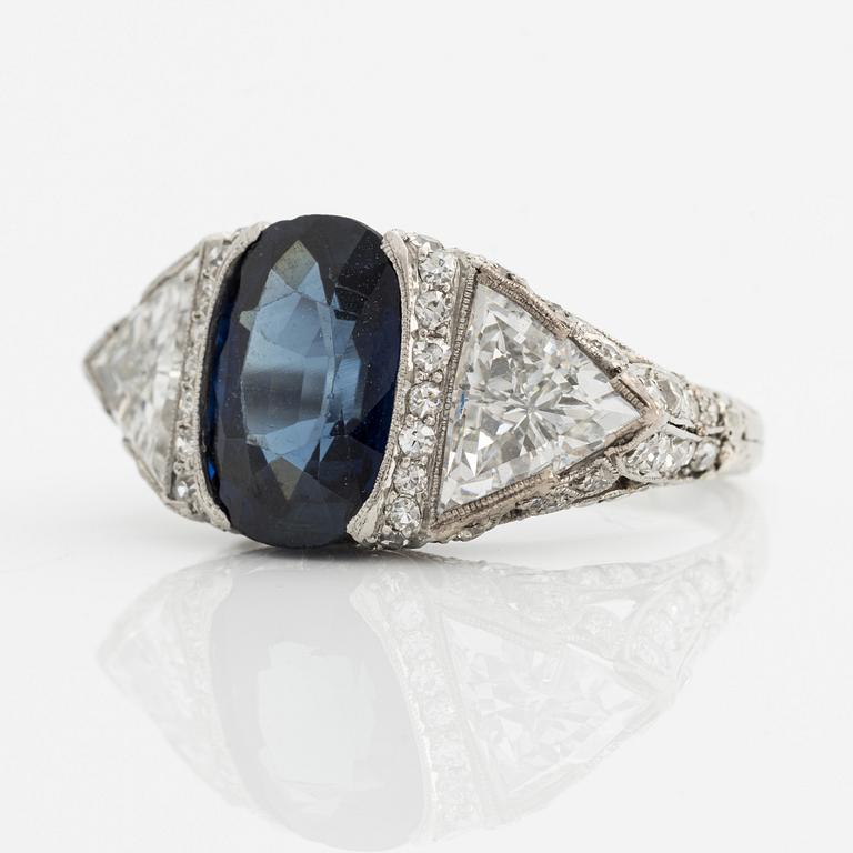 A platinum ring set with a faceted sapphire.