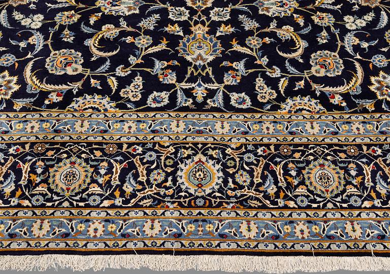 A Keshan carpet, signed, approx. 430 x 320 cm.