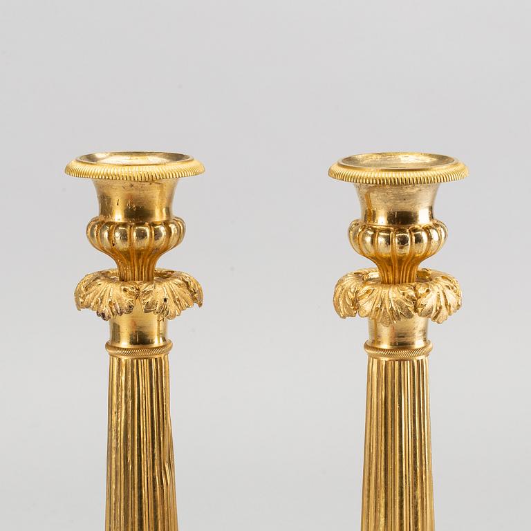 A pare of late empire candelsticks mid 19th century.