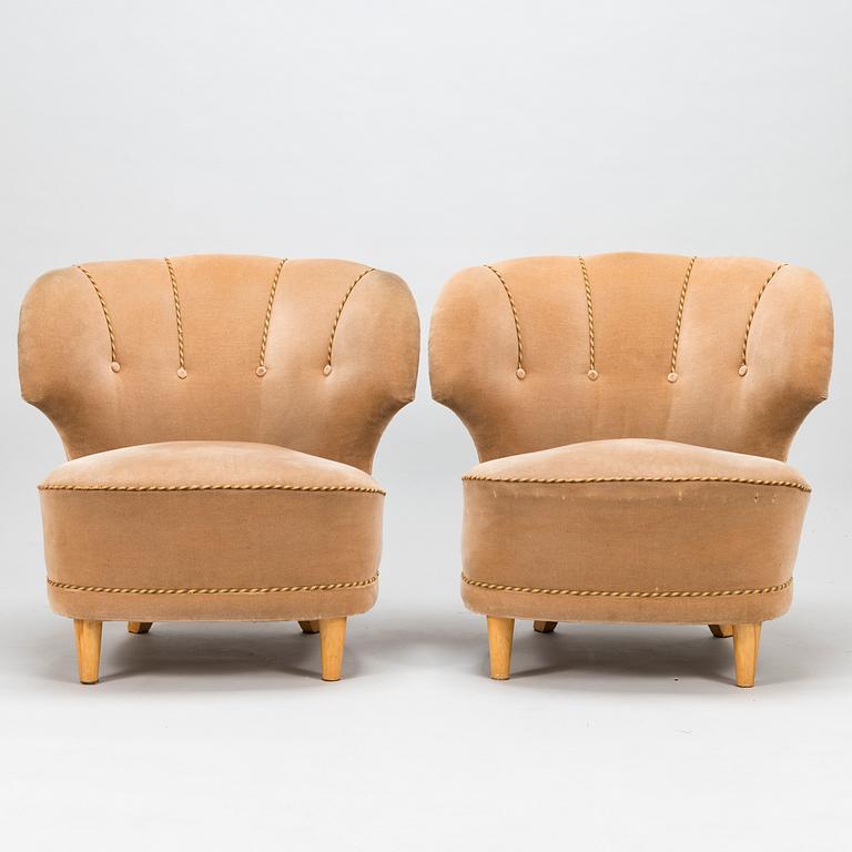 A pair of mid-20th-century armchairs.