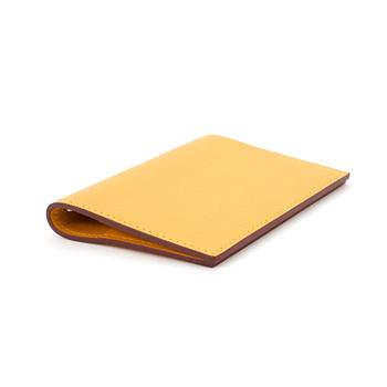 HERMÈS, a yellow leather agenda cover, "Globe Trotter".