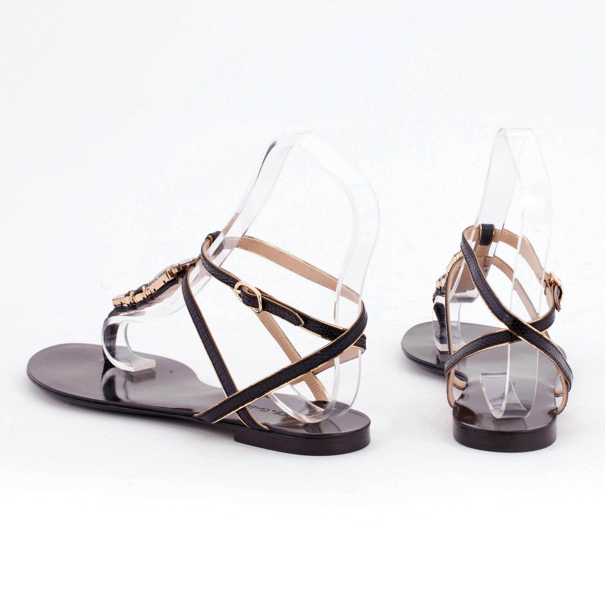DOLCE & GABBANA, a pair of black leather sandals.