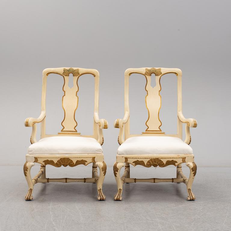 A 19th century pair of late baroque style armchairs.