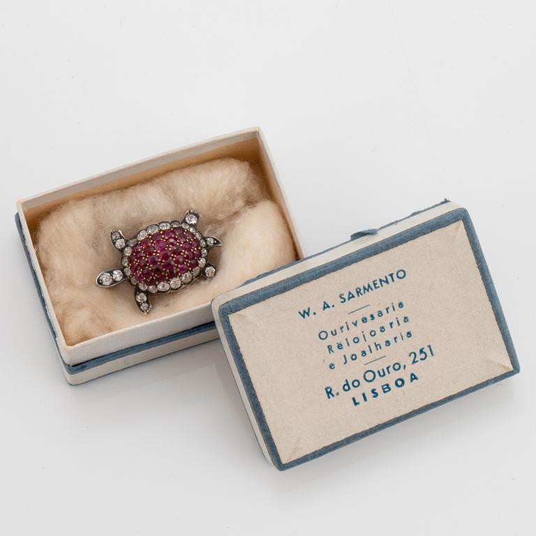 A silver and 14K gold brooch set with old-cut diamonds and rubies.