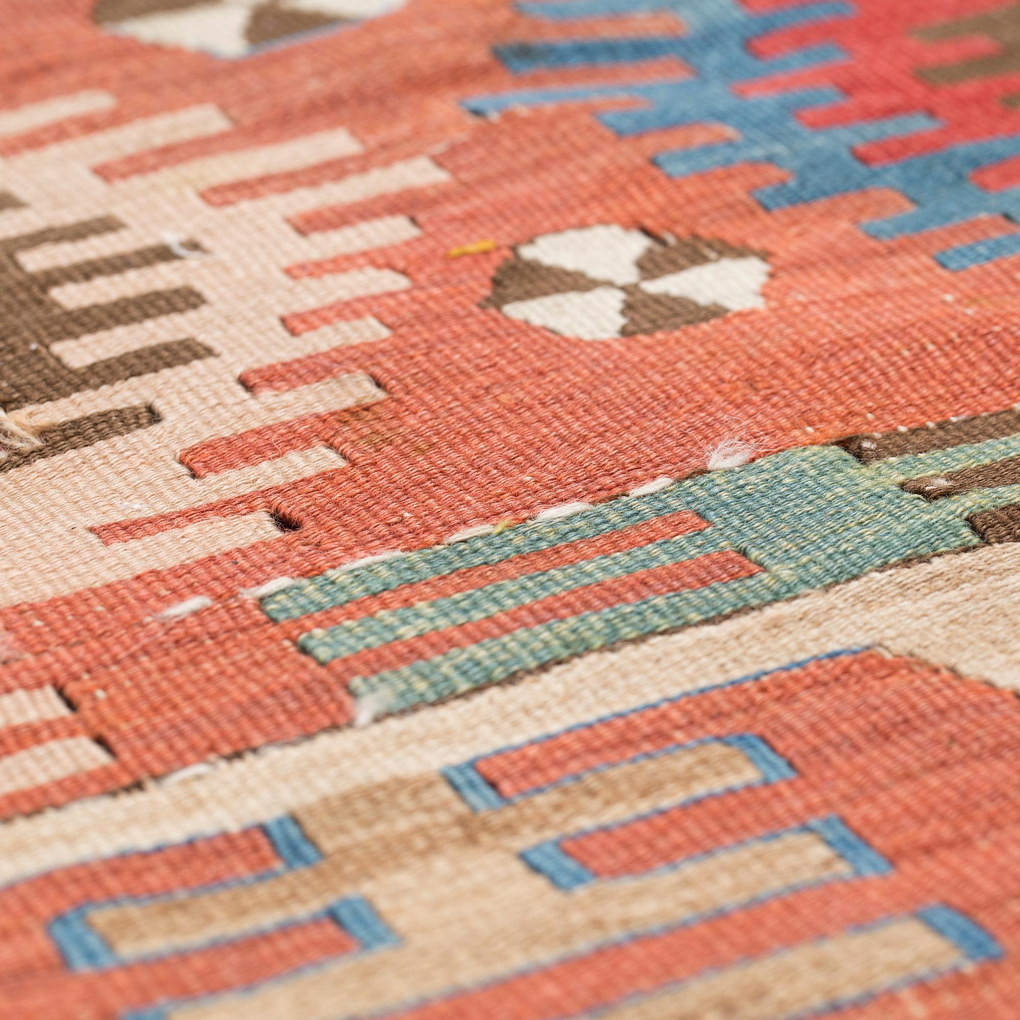 An antique Anatolian kilim fragment in form of a drape, around 232 x 76 cm.