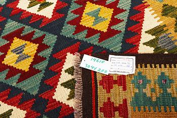 An Afghan Kelim carpet, c. 304 x 200 cm.