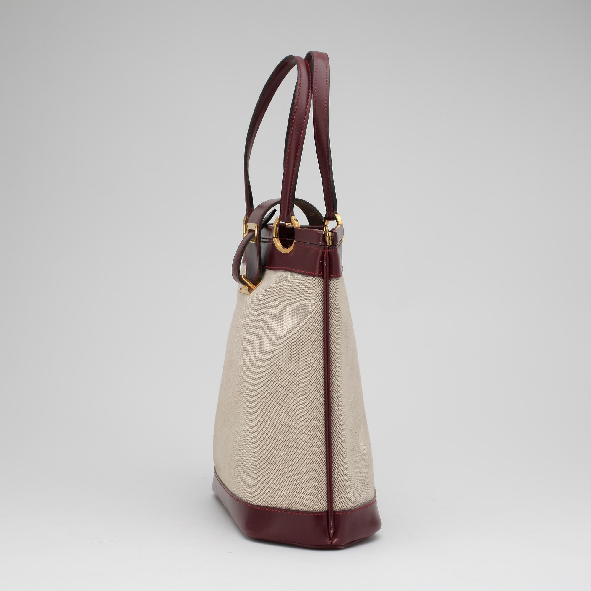 HERMÈS, a canvas and leather handbag.