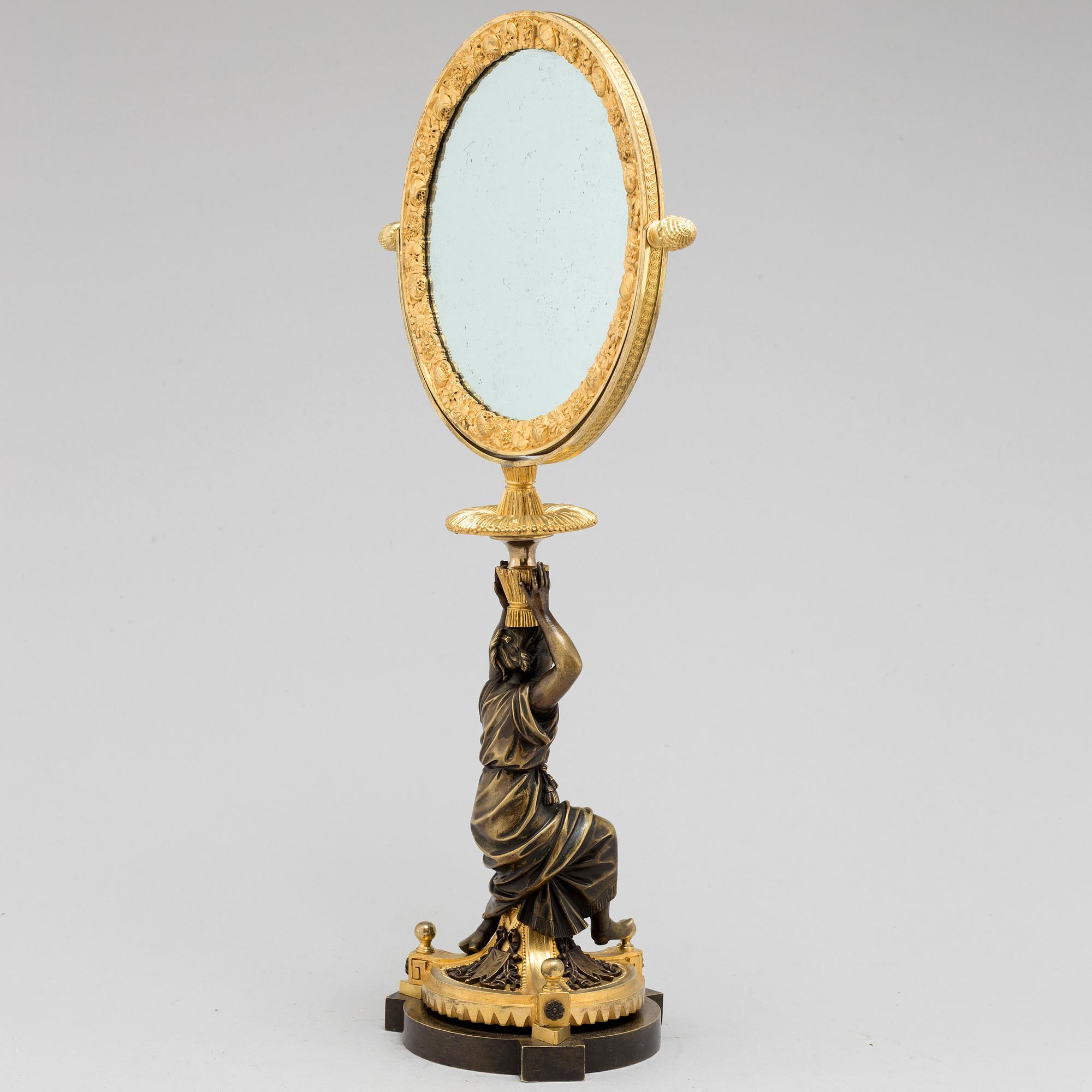 AN EMPIRE ORMOLU TABLE MIRROR, first half of the 19th century.
