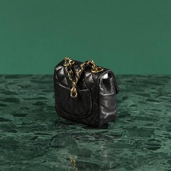 Belt with mini flap-bag by Chanel.