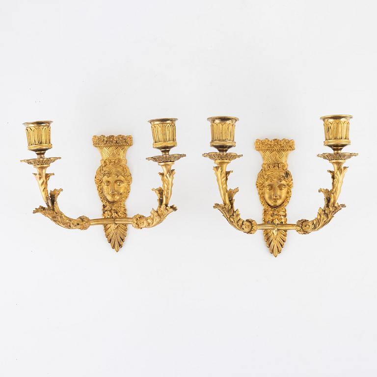 A pair of Empire-style ormolu two-light wall lights, 19th Century.