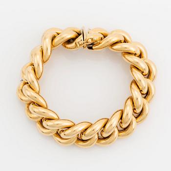An 18K gold bracelet.