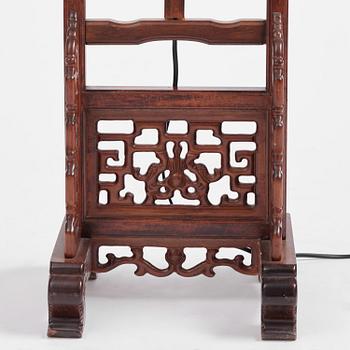 A Chinese wooden floor lamp, later part of the 20th century.