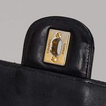 CHANEL, a quilted black leather 'Double Flap Bag'.