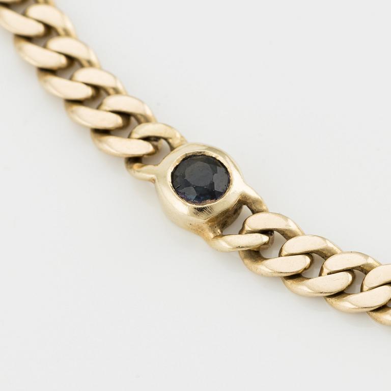 Bracelet, 14K gold with rubies, sapphires, and emerald.