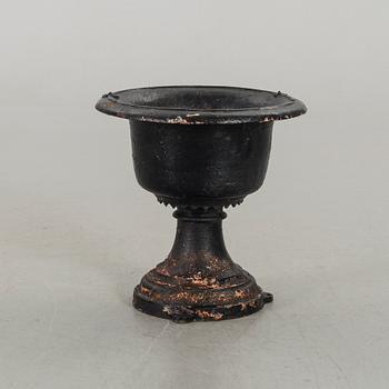 A CAST IRON GARDEN URN.