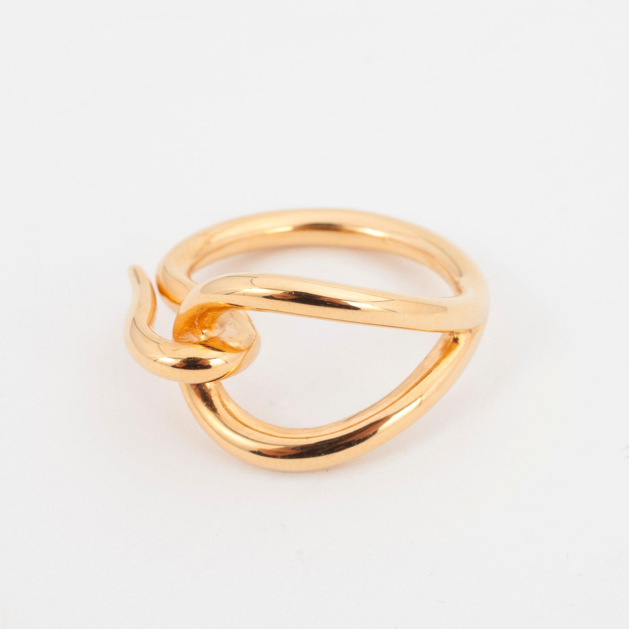 HERMÈS, a gold colored scarf buckle.