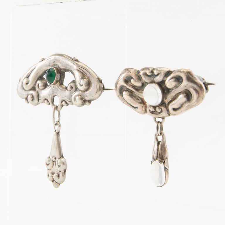 Brooches, 2 pieces, Art Nouveau, early 20th century, pewter, moonstone, and green stone.