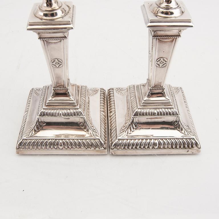 An English 20th century pair of silver candle sticks mark of Mappin & Webb London around 1900.