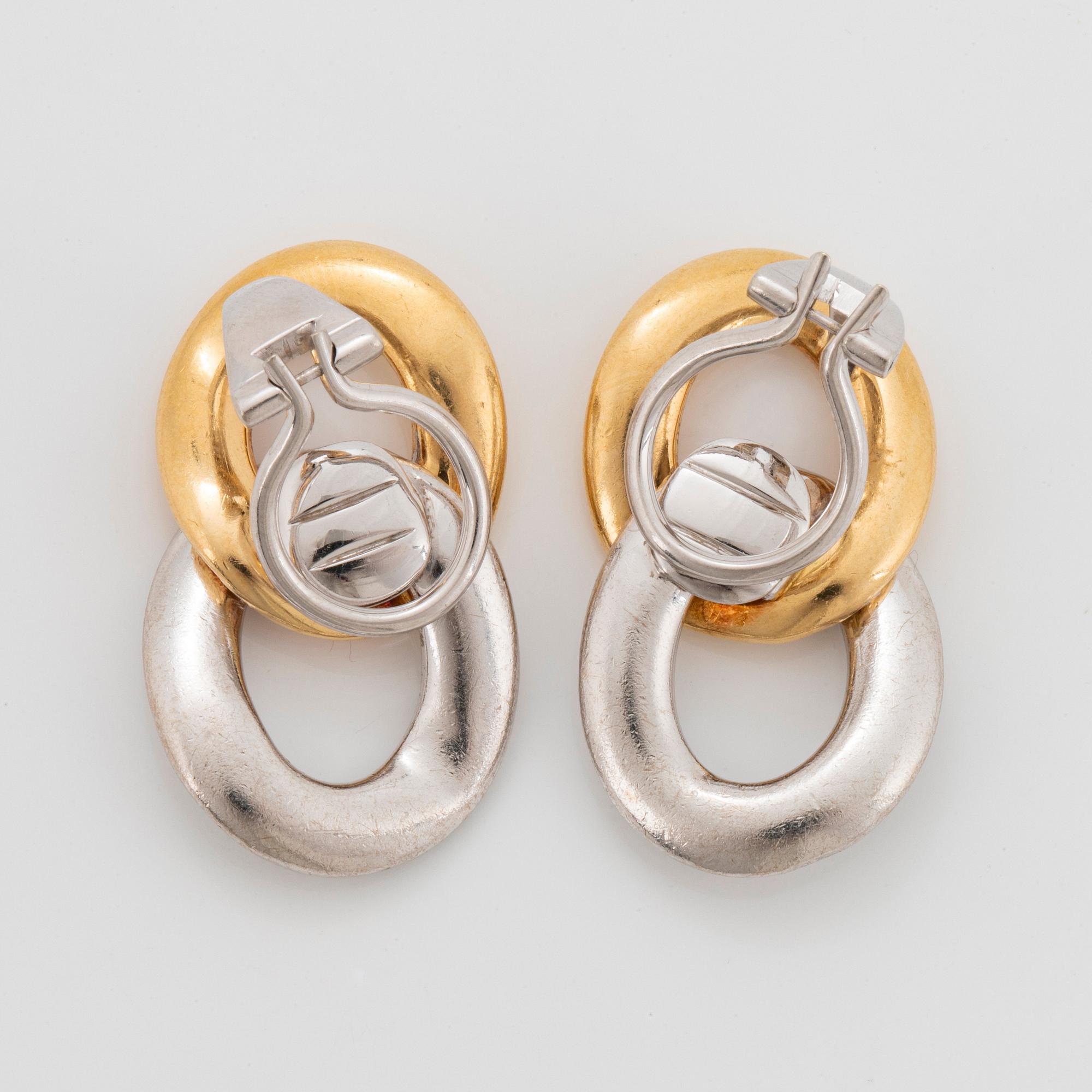 A pair of 18K gold and white gold Meister earrings set with round brilliant-cut diamonds.