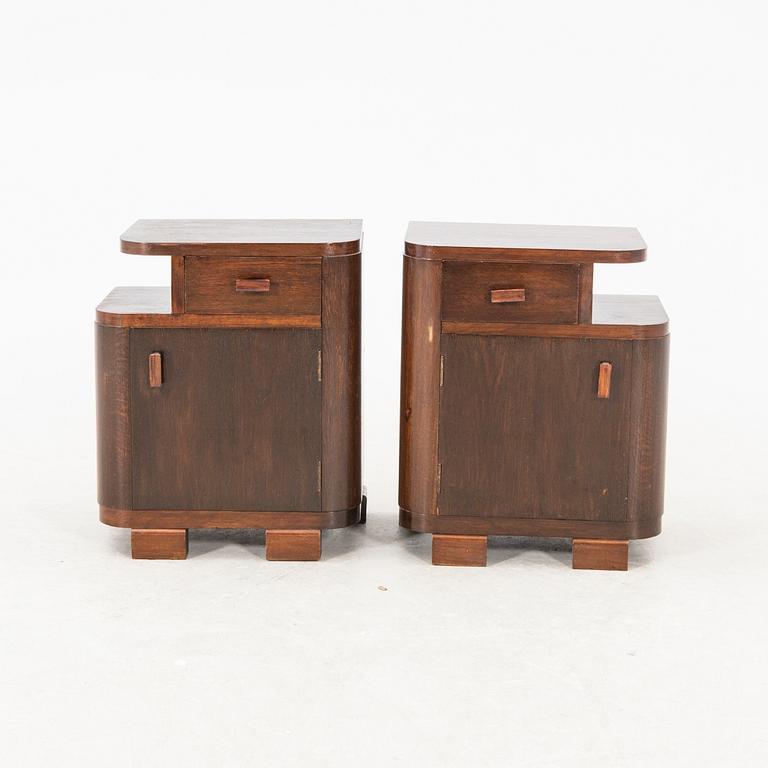 A pair of stained wood bedside tables from the first half of the 20th century.