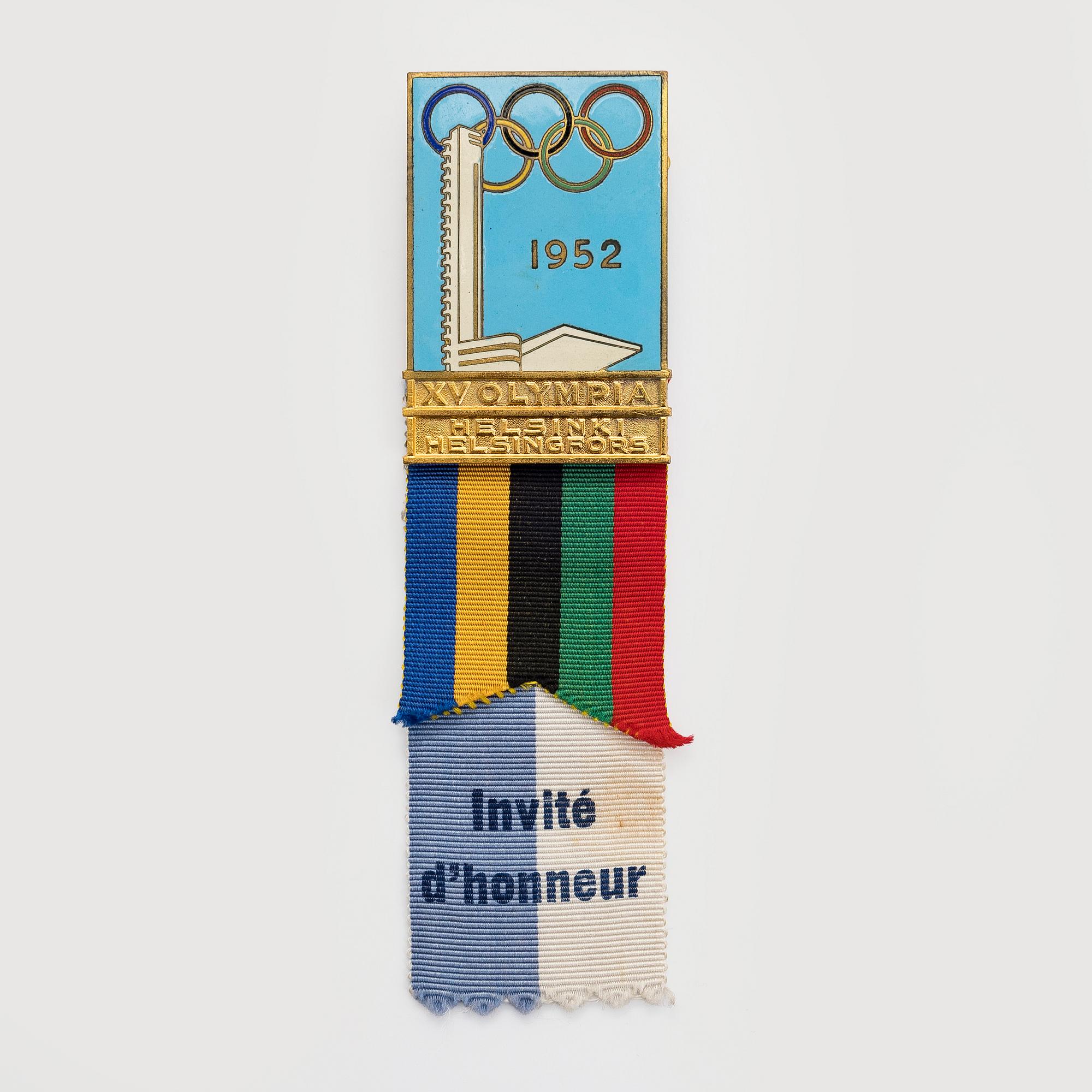 The Finnish olympic cross, 1st class, silver and enamel. Tillander, Helsinki and a Guest of Honor pin.