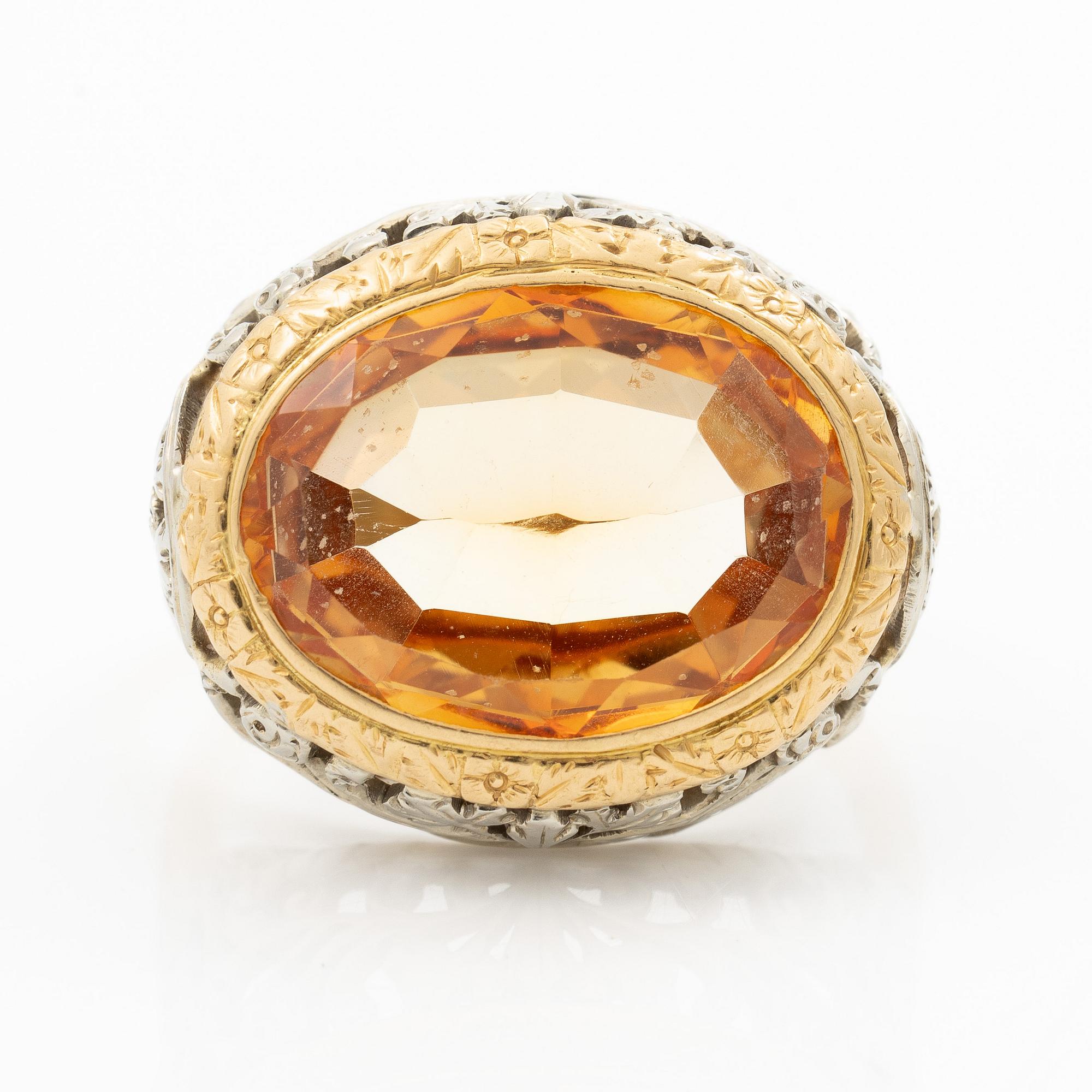 Gold ring with synthetic yellow sapphire.