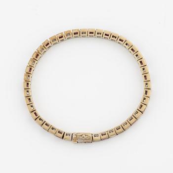 A bracelet in 18K white gold with rubies and princess-cut diamonds.