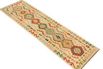 A Kilim runner carpet, c. 291 x 77 cm.