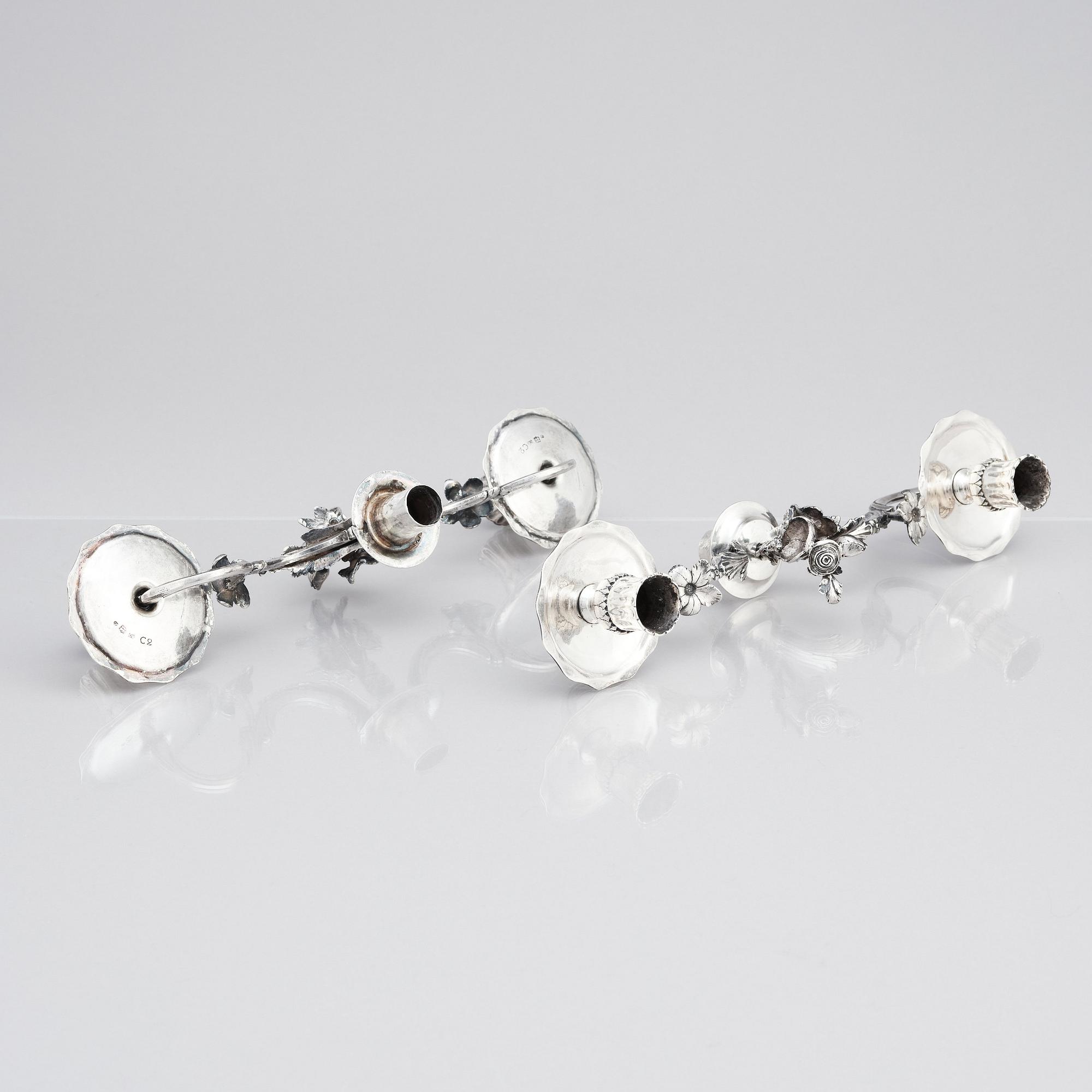 A pair of Swedish 18 century silver candelabras, mark of Lars Åkerblom Gävle 1775, arms by Christian Kullberg.