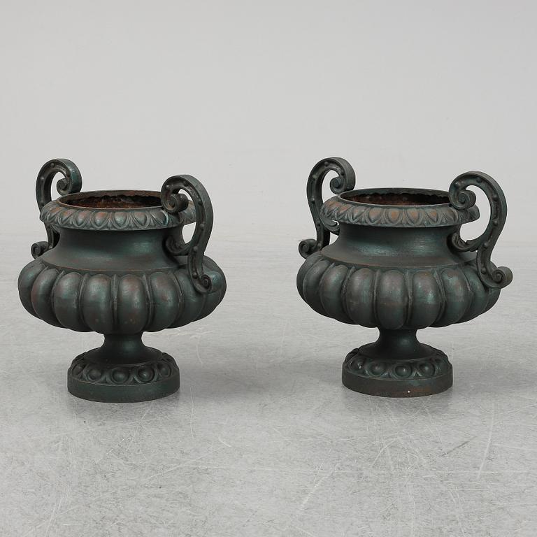 A 20th Century pair of cast iron flower pots.