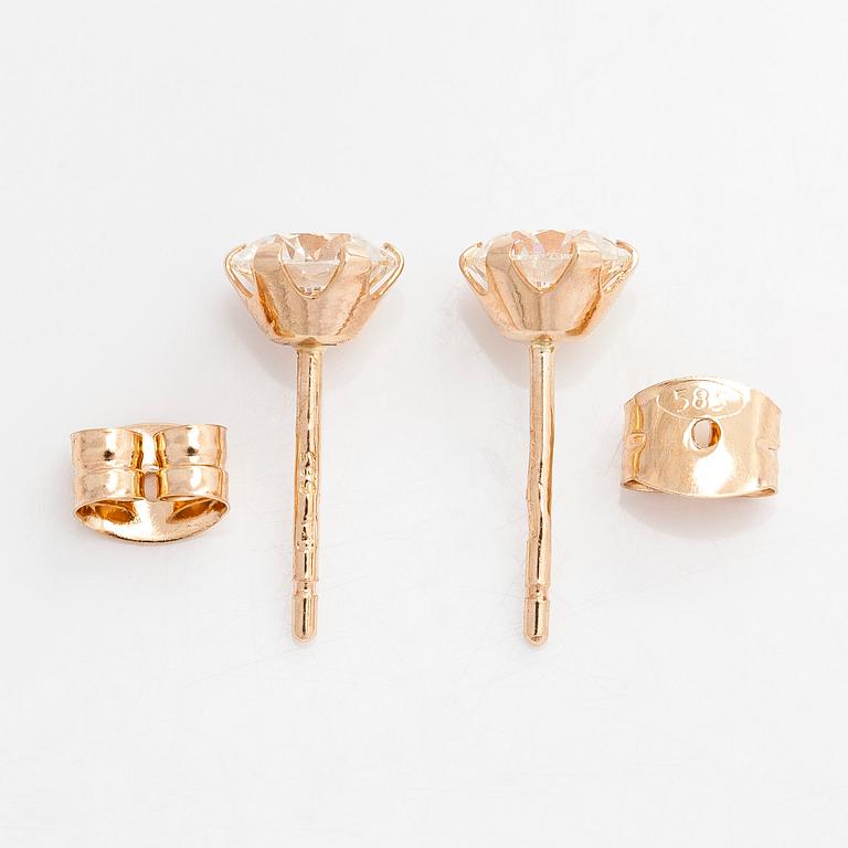 A pair of 14K gold earrings and brilliant cut diamonds.