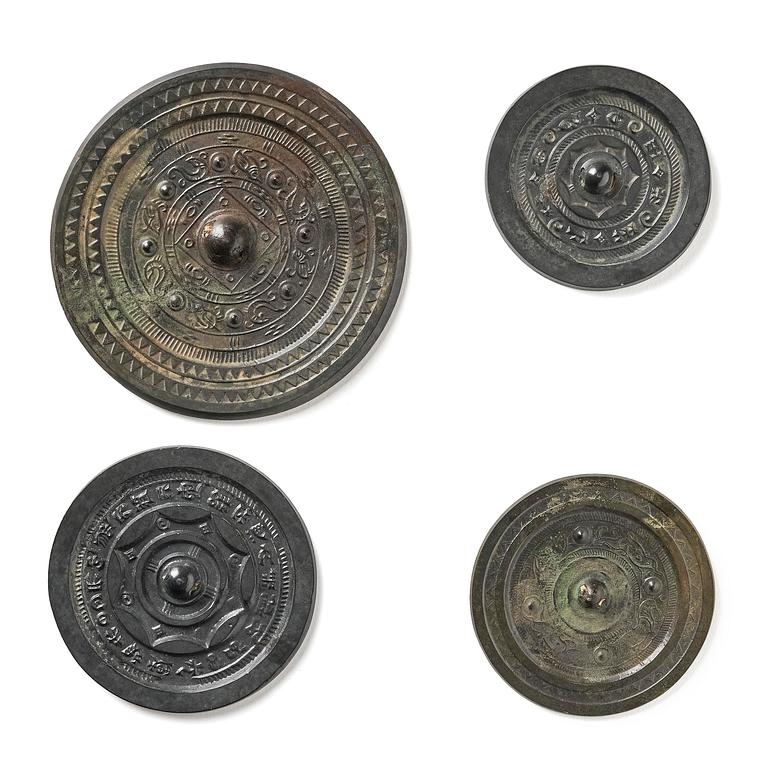 Four silvered bronze mirrors, Han dynasty (220 B.C. - 206 A.D).