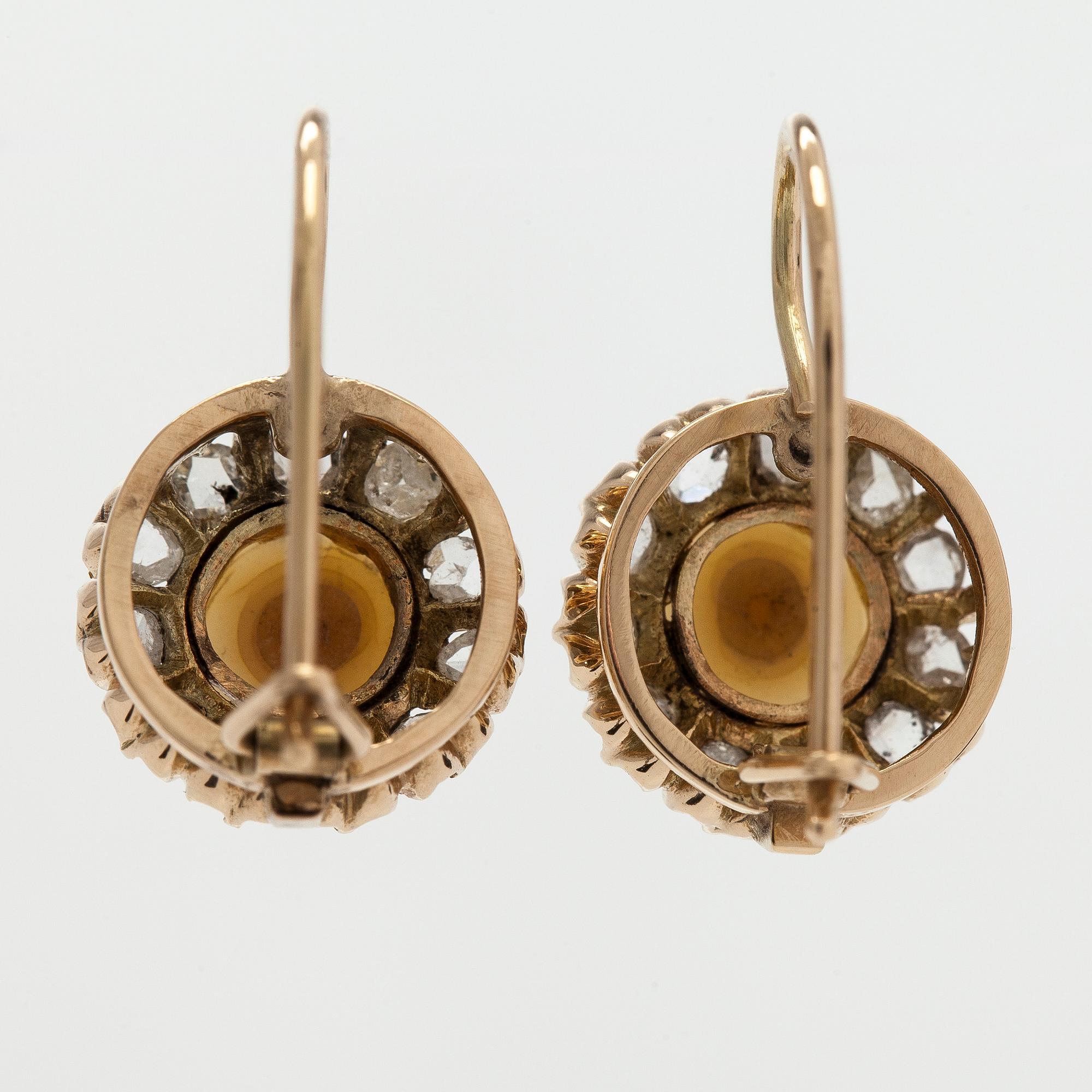 A pair of 14K gold earrings with cultured halfpearls and rose-cut diamonds.