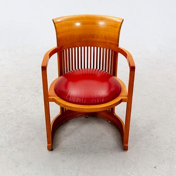 A cherry wood model 606 'Barrel' chair by Frank Lloyd Wright from Cassina.