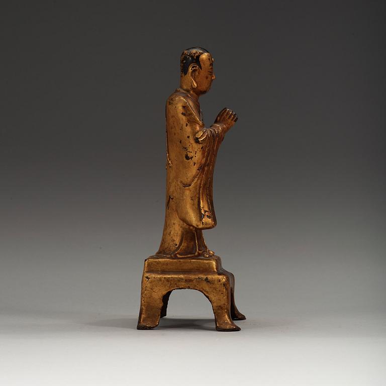 A lacquered gilt figure of a standing monk, Ming dynasty (1368-1644).