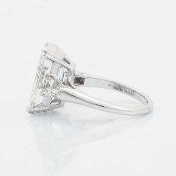 A platinum ring set with an emerald-cut diamond.