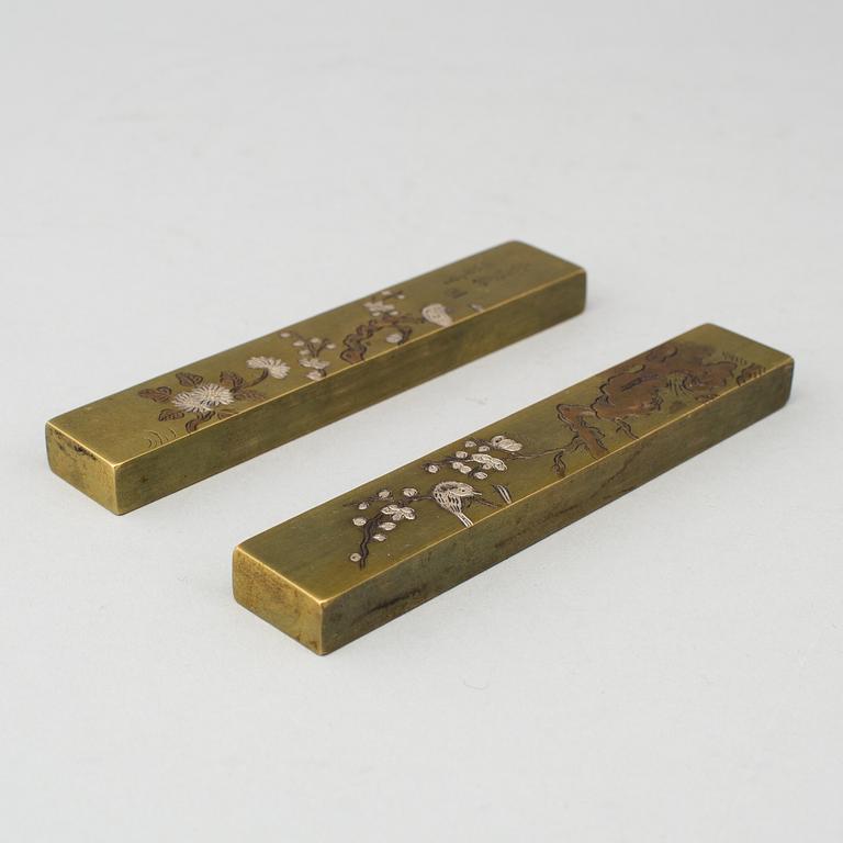 A pair of Japanese scroll weights, early 20th Century.