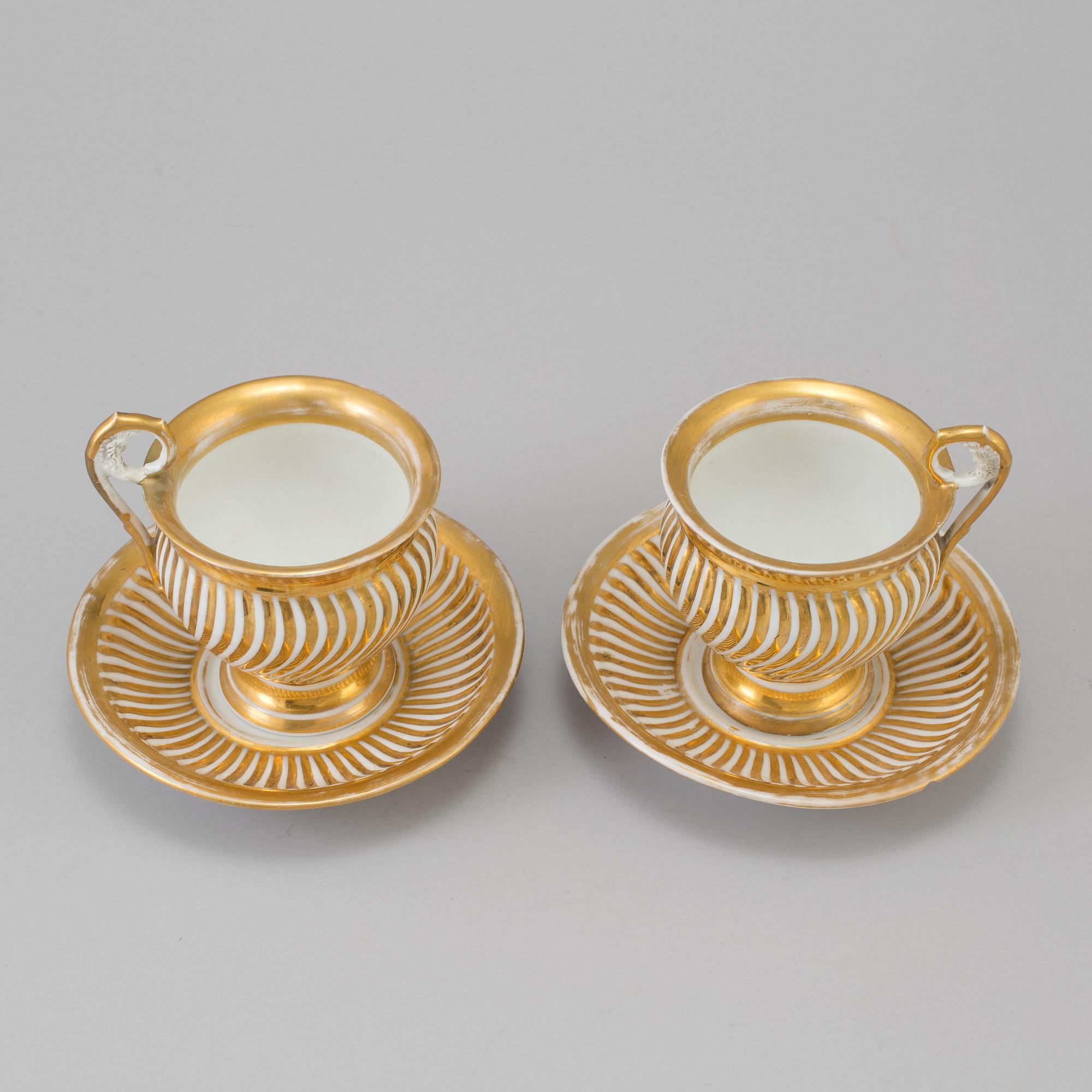 a pair of late empire porcelain cups with saucers from the first half of the 19th century.