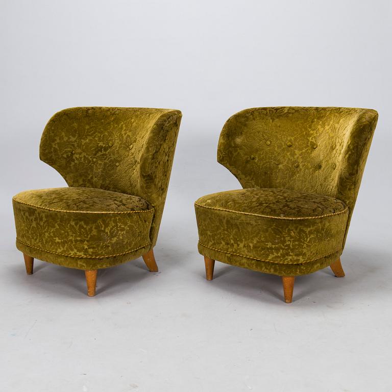 A pair of mid-20th-century armchairs.