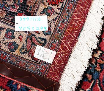 An antique Mashad carpet, signed Saber, c. 405 x 295 cm.