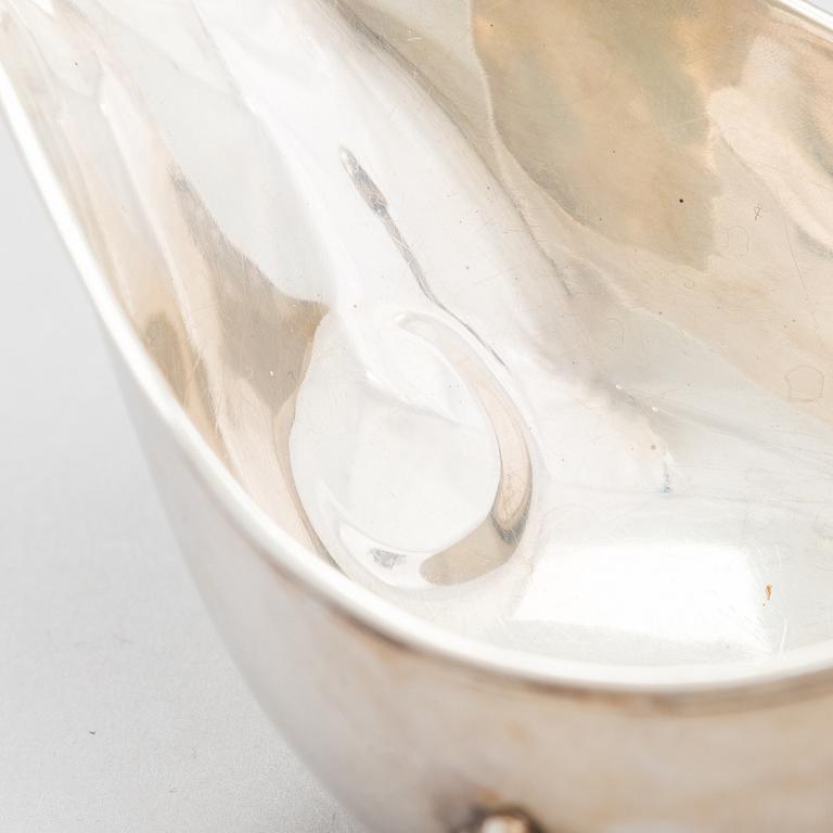 A pair of sauce jugs, maker's mark of Charles & George Asprey, London 1904, and 20th-century sauce jug. Sterling silver.