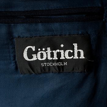 GÖTRICH, a dark blue club blazer and grey wool pants.