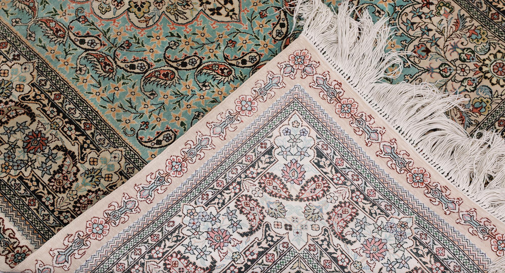 An Oriental silk rug, approx. 154 x 91 cm.