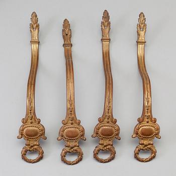 SEVEN BRONZE CURTAIN TIE-BACKS (4+3), 19th century.