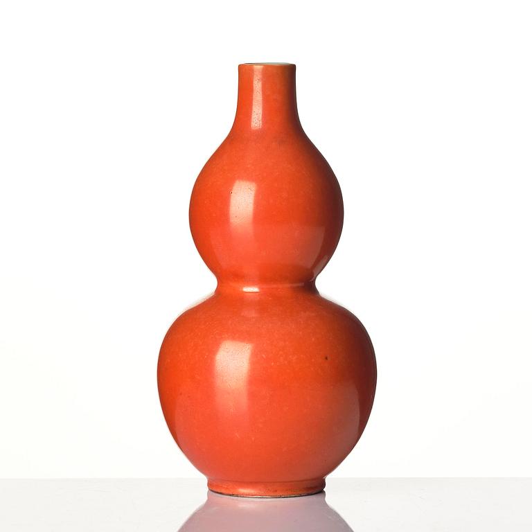 A coral red-enameled double-gourd vase, Qing dynasty with Jiaqing mark (1796-1820).