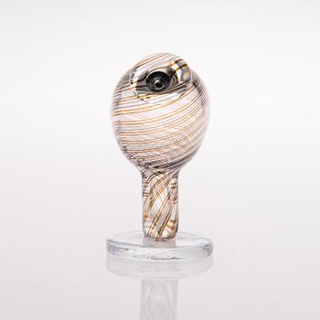 A footed glass bird signed O. Toikka Nuutajärvi.