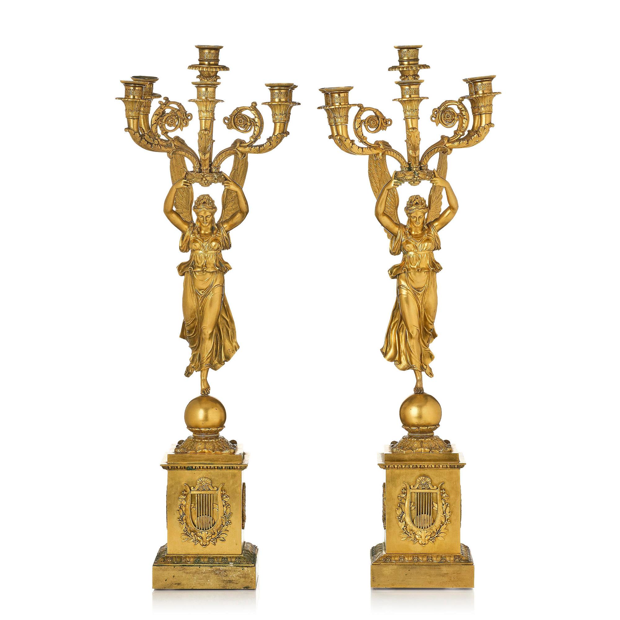 A pair of six-branch gilt bronze Empire candelabra, Paris, early 19th century.