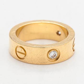 Cartier, an 18K gold 'Love' ring with three brilliant-cut diamonds.