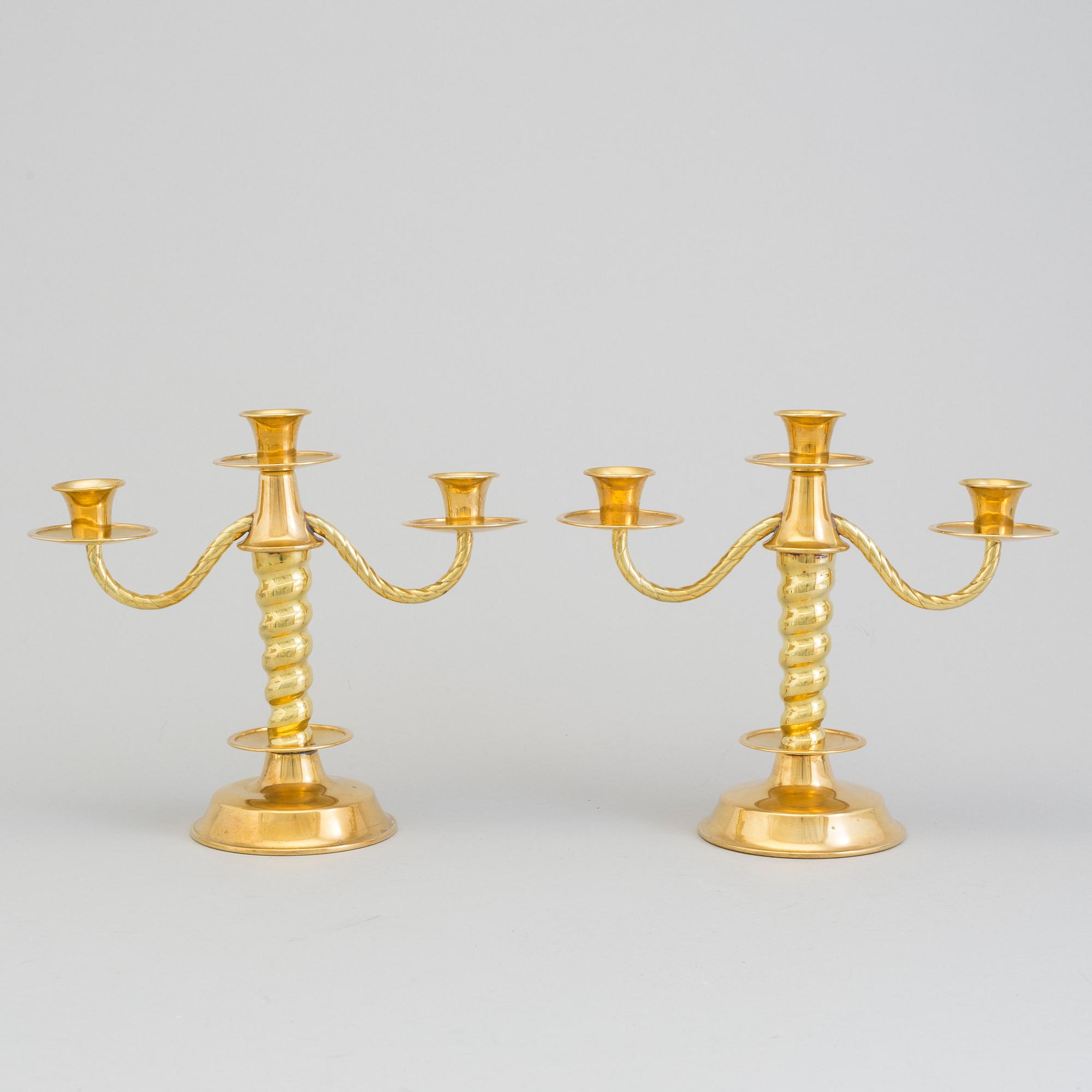 a pair of brass candelabras by Gottfrid Carlsson Eskilstuna.